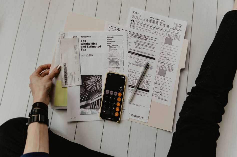 Blog hero banner showing budgeting planner, calculator, and coins on desk
